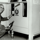 A man demonstrates an early-model Tomra reverse vending machine in Canada.